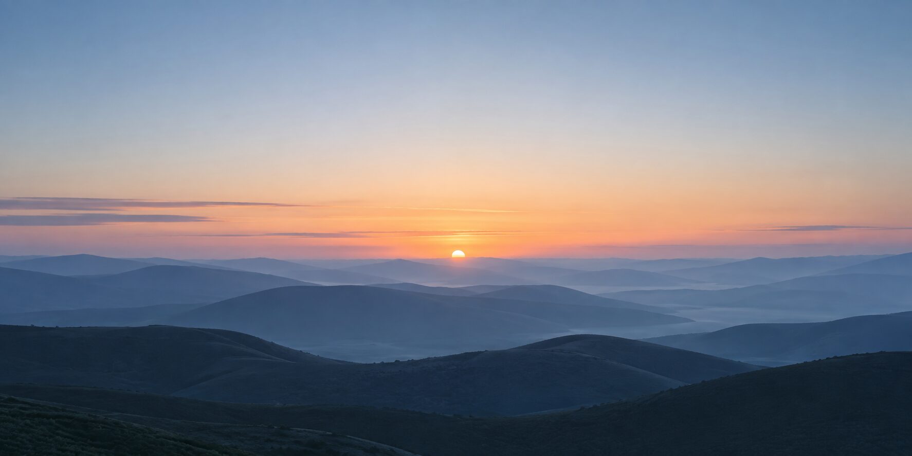 Sunrise over misty mountains